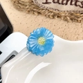 Blue and green acetate sunflower hair claw clip placed on a white ceramic bowl edge - Daisy / Blue