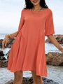 Outdoor shot of a coral orange crew neck beach dress against coastal rocks and ocean - S / Dresses / Orange