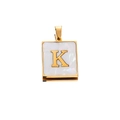 Macro detail of square stainless steel pendant with letter K and white shell inlay - Gold K
