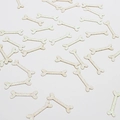 Iridescent bone-shaped confetti in creamy white color for Halloween party decorations - Colorful Bone