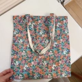 Macro view of floral canvas tote bag showing the vibrant printed fabric and beige lining - T-39 Pink Purple Green Floral