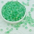 Close-up of mint green frosted glass beads with gold foil inside for DIY jewelry - 6mm Green with Gold Glitter