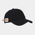 Detail der Vintage-Baseballkappe mit weißem Webetikett, braunem Leder und einer Niete - Schwarz