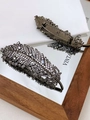 Gunmetal feather brooch with sparkling white zircon crystals and spring clip detail - Black White Zircon