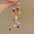 Detailed close-up of long dangling earrings with colorful star-shaped beads in vibrant hues - Colorful Star Beads (16#)