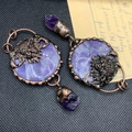 Detail of vintage bronze earrings with lion relief, purple gemstones and raw crystals - Amethyst Lion Head