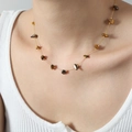 Elegant gold titanium steel necklace featuring irregular brown natural stone charms on a model - Tiger Eye Stone (P018)