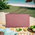 Pink grainy leather long wallet with wristlet strap and gold zipper on a picnic mat - Dark Pink