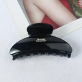 Glossy black hair claw clip featuring gold Barrette LaFrance lettering on the side - Glossy Black with Logo