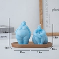 Artistic body shape candles in sky blue finish displayed on a wooden tray - Sitting Posture / Blue