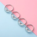 Detailed view of four polished silver oval signet rings on a pastel split background - US 9 / Steel