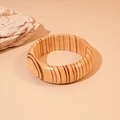 Close-up of minimalist wooden bangle with natural wood grain texture on stone background - Coffee Thick Style
