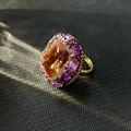 Detail of vintage ring featuring large orange gemstone surrounded by purple crystals - K-0838 Zultanite Open Ring