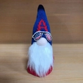 Patriotic gnome doll with blue knit hat featuring red letter A and flag pattern glasses - Style A