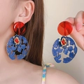 Elegant retro blue floral hollow earrings with red beads shown on an Asian model detail view - 14# Silver Post Stud - Gold/Red/Blue