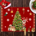 Close-up of a festive red Christmas placemat with reindeer and tree on wooden table - CD30-21