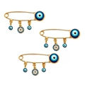 Detail von drei goldenen Evil Eye Broschen mit blauen Kristallen auf weißem Grund - Gold 001