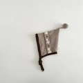 Detail of baby knitted earflap hat with Nordic jacquard pattern and pompom top - 6-24 Months / Brown