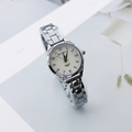Detailed close-up of a silver ladies watch with vintage engraved bezel and quartz dial - Silver White Dial