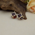 Macro detail of wine red square resin pendants with irregular gold foil edges for DIY jewelry - Burgundy