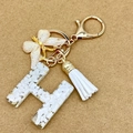 Letter H resin keychain with white stone, gold leaf, butterfly and white leather tassel - Letter H
