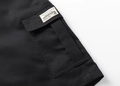 Close-up of durable black cotton twill fabric and side cargo pocket with label detail - XS / Black (Detail 3)