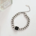 Detailed view of silver Cuban chain bracelet featuring a black enamel square charm - Cuban Black Tag Bracelet (T134) / Steel