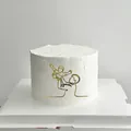 Detail view of 8.7cm gold acrylic cake topper showing a minimalist parent and child silhouette - Father Lifting Child / Gold