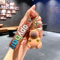 Cute brown capybara keychain with a yellow backpack and a brown wave rubber strap - B228-2 Backpack