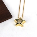 Macro shot of gold star pendant with letter A zircon inlay on white textured fabric - Letter A