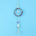 Detail of amethyst moon star suncatcher with faceted crystal ball on blue background - Purple Crystal