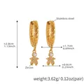 Detailed view of gold stainless steel huggie earrings with textured band and zircon charm - Gold-Q138