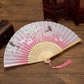 Detail of a foldable fan with cherry blossom and rabbit patterns and pink tassel charm - Pink Jade Rabbit