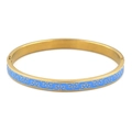 Detail view of gold-tone stainless steel bangle with blue enamel daisy floral pattern - Gold Blue