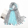 Detail of soft voile shawl with blue floral print and fringe tassels on white background - Sky Blue