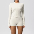 Detail of cream white yoga set featuring zip-up jacket with V-hem and high waist shorts - Light Ivory
