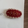 Detail of crochet hair clip featuring red yarn, pearl accents, and gold thread patterns - Christmas Series - Red Oval