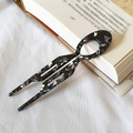 Acetate U-shaped hair pin with black and white marble pattern on a vintage book - Black Floral