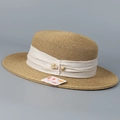 Detail of boater straw hat featuring white decorative band and UV 99% protection tag - M (56-58cm) / Khaki