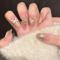 Detail of luxury press-on nails with golden lion dance charm and 3D butterfly accents - Extra Small (XS) / Short Oval