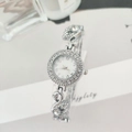 Close-up of silver watch featuring crystal-encrusted swan links and a luxury rhinestone bezel - Silver