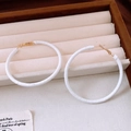 Detailed view of textured white round hoop earrings with gold accents on a beige tray - 32# White Leather Texture Wrap Large Hoop 6cm