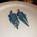 Macro detail of leaf-shaped rhinestone tassel earrings with blue and green gradients - Style 10 Silver Post / Blue