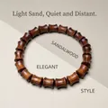 Dark brown pearwood bracelet featuring polished drum-shaped beads with natural wood grain - 8mm Bamboo Joint Single Loop
