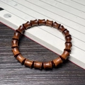Dark brown pearwood bracelet featuring polished drum-shaped beads with natural wood grain - 8mm Bamboo Joint Single Loop