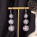 Close-up of Bohemian triple-layer mandala tassel earrings on gold display stand - S4290-1 Pink Enamel Mixed Triple Ring Earrings