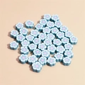 Macro shot of 10mm blue flower-shaped polymer clay beads for DIY jewelry making - Lake Blue