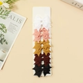Set of 10 ribbed bow clips in white, pink, yellow, brown, and black on a card - White Pink Mustard Yellow Dark Brown Black (#25)