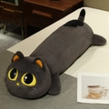 Long grey plush cat pillow with yellow eyes and orange inner ears on a wooden bed - Gray