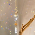 Modern sun catcher with gold moon frame and crystal heart creating rainbow reflections - B26 Style